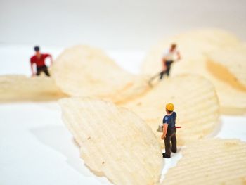 Close-up of figurines on potato chips