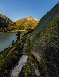 Scenic view of lake and mountains against clear sky