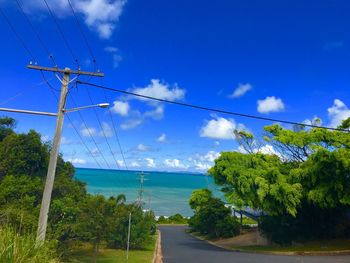 Scenic view of trees against blue sky