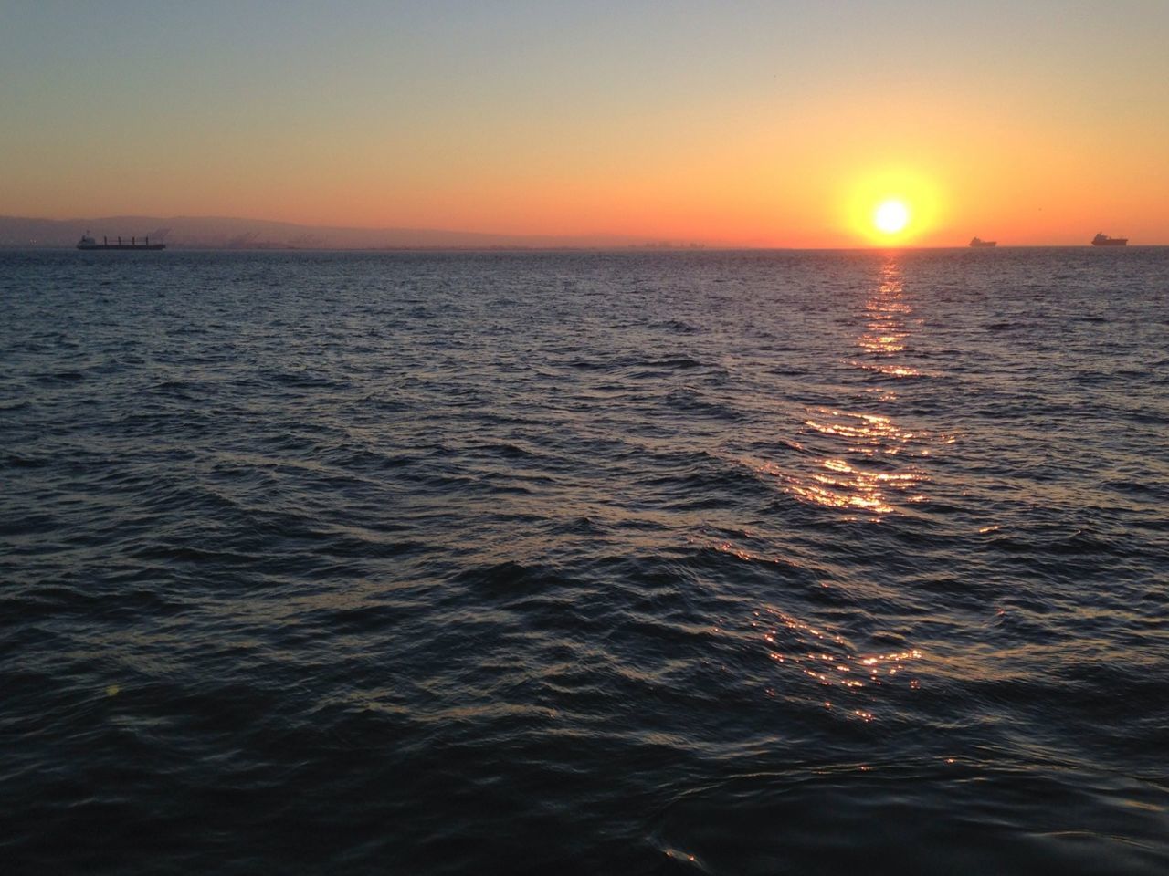 sunset, water, sea, sun, scenics, waterfront, beauty in nature, tranquil scene, orange color, tranquility, horizon over water, rippled, idyllic, nature, reflection, sky, clear sky, seascape, sunlight, wave