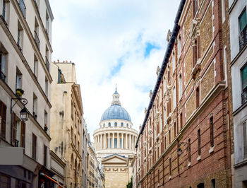 Low angle view of pantheon in city against cloudy sky