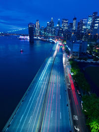 High angle view of light trails on city street at dusk