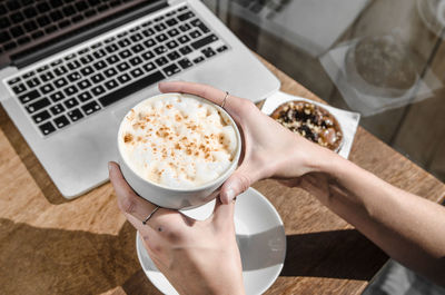 High angle view of woman drinking coffee