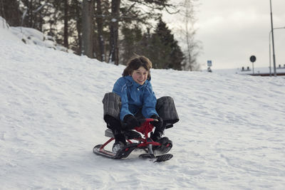 Teenage boy sledging