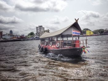 Built structure in water against cloudy sky