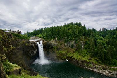 Scenic view of waterfall against sky