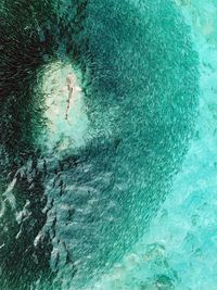 High angle view of woman swimming in sea