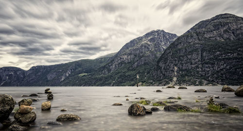 Scenic view of sea and mountains against sky