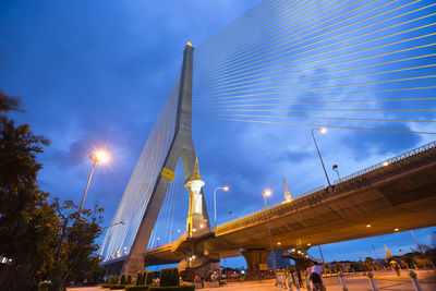 Low angle view of illuminated bridge against blue sky