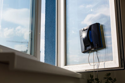 Detail of a glass cleaning robots acting behind a window