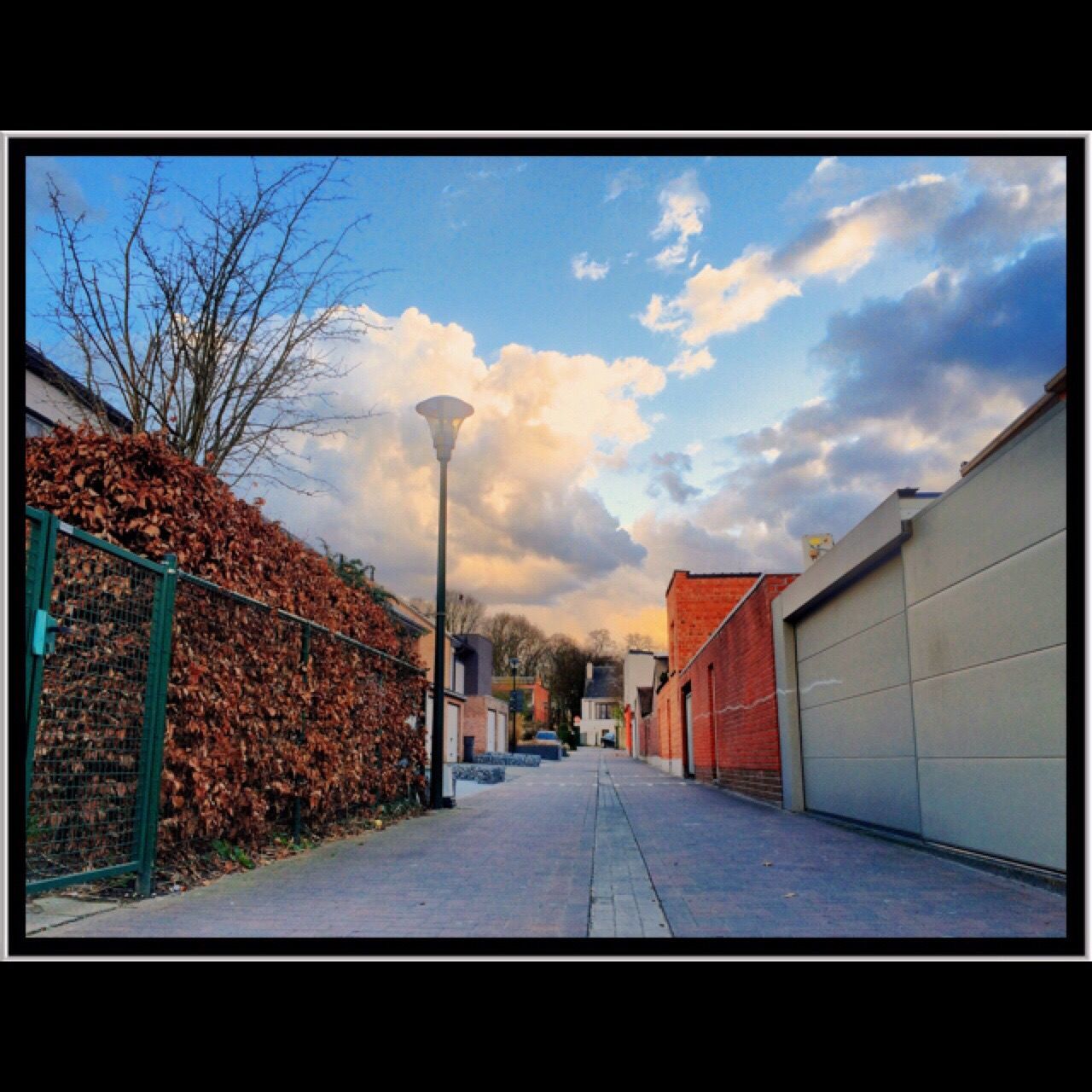 architecture, building exterior, built structure, the way forward, sky, diminishing perspective, house, residential structure, residential building, transfer print, cloud - sky, vanishing point, auto post production filter, city, tree, street, residential district, road, building, cloud