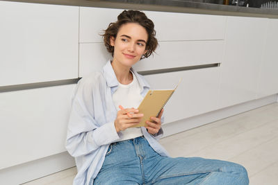 Portrait of young woman using mobile phone