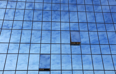Reflection of sky on modern glass building