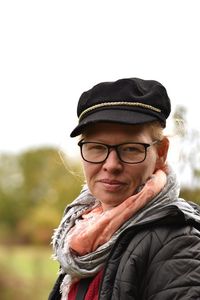 Portrait of young man standing against clear sky