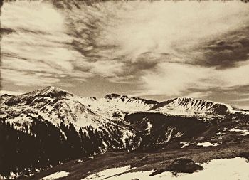 Scenic view of snow covered mountains against sky