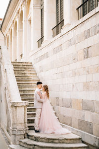 Full length of a woman standing in front of building
