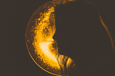 Close-up of electric lamp against black background