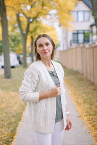 Portrait of young woman standing outdoors