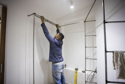 Rear view of man working at home