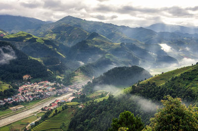 High angle view of trees and mountains against sky