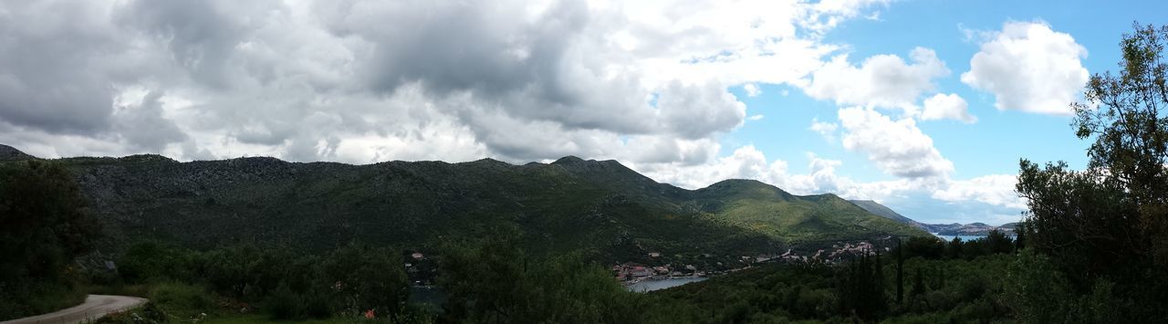 sky, tranquil scene, mountain, tranquility, scenics, cloud - sky, beauty in nature, tree, landscape, cloud, nature, cloudy, mountain range, non-urban scene, green color, idyllic, growth, day, remote, outdoors