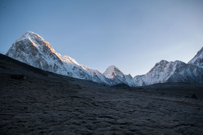 Scenic view of snowcapped mountains against clear sky