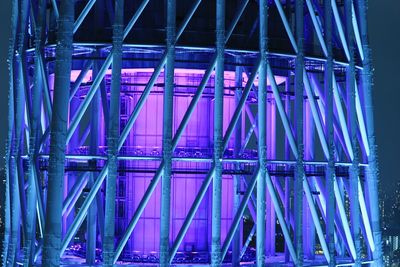 Metallic bridge against sky at night