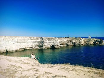 Scenic view of sea against clear blue sky