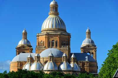 Low angle view of church against clear blue sky