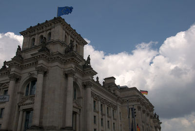 Low angle view of building against cloudy sky