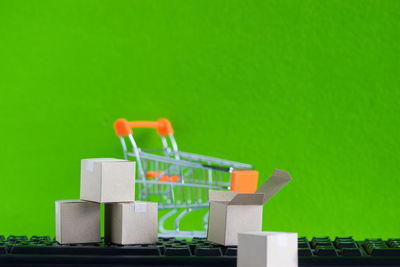 Close-up of toys on table against green background