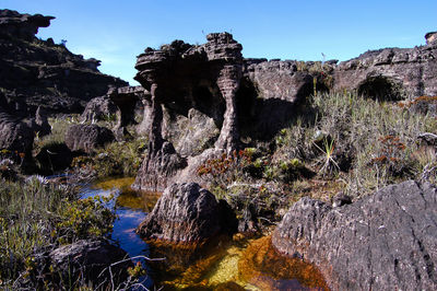 Rock formation amidst rocks against sky