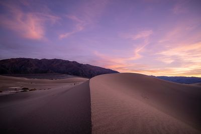 Scenic view of desert against sky during sunset