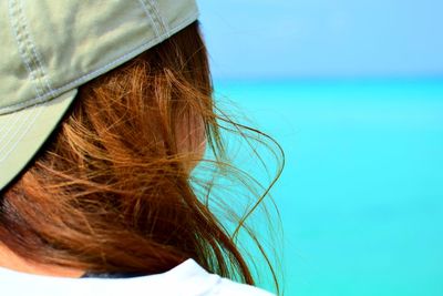 Close-up of woman with blond hair looking at sea