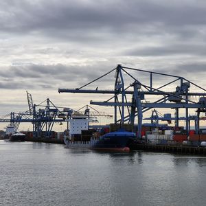 View of commercial dock against cloudy sky