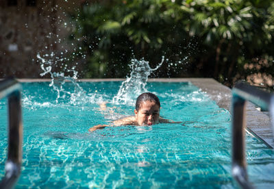 Portrait of man swimming in pool