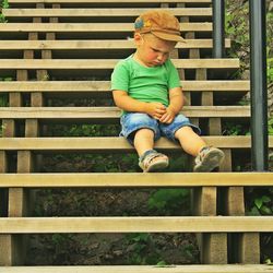 Full length of a boy sitting on staircase