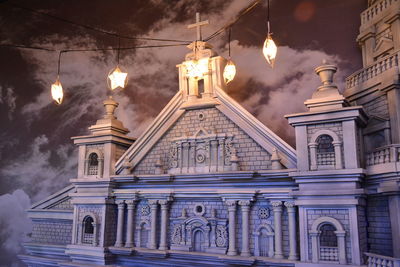 Low angle view of illuminated building against sky