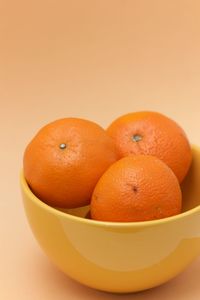 Close-up of orange fruit against white background