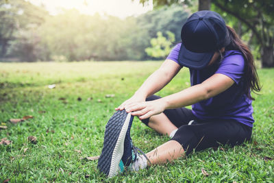 Woman exercising on field