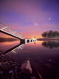 Scenic view of lake against sky at night