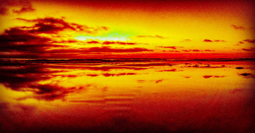 Scenic view of dramatic sky over sea during sunset