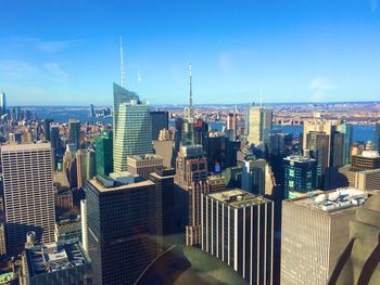 Aerial view of cityscape against blue sky