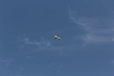 Low angle view of airplane flying in sky