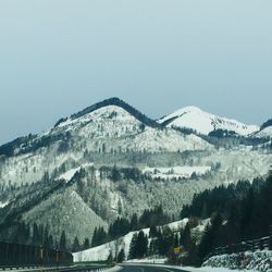 Scenic view of snowcapped mountains against clear sky