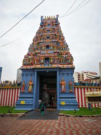 Group of people outside temple against building