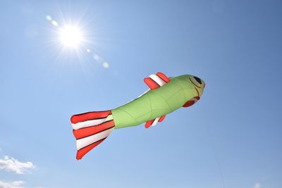 Low angle view of kite flying against blue sky