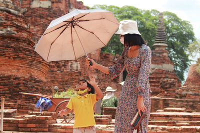 High angle view of woman holding umbrella during rainy season