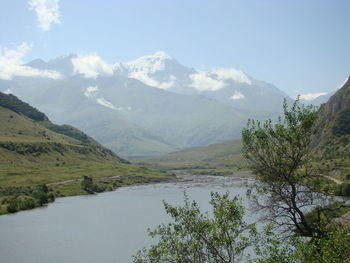 Scenic view of lake and mountains against sky