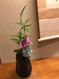 Close-up of potted plant on table against wall